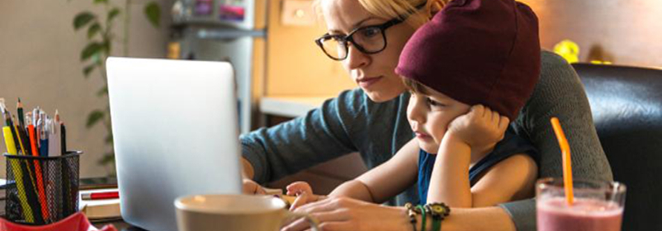 Younger and older person looking at an open laptop