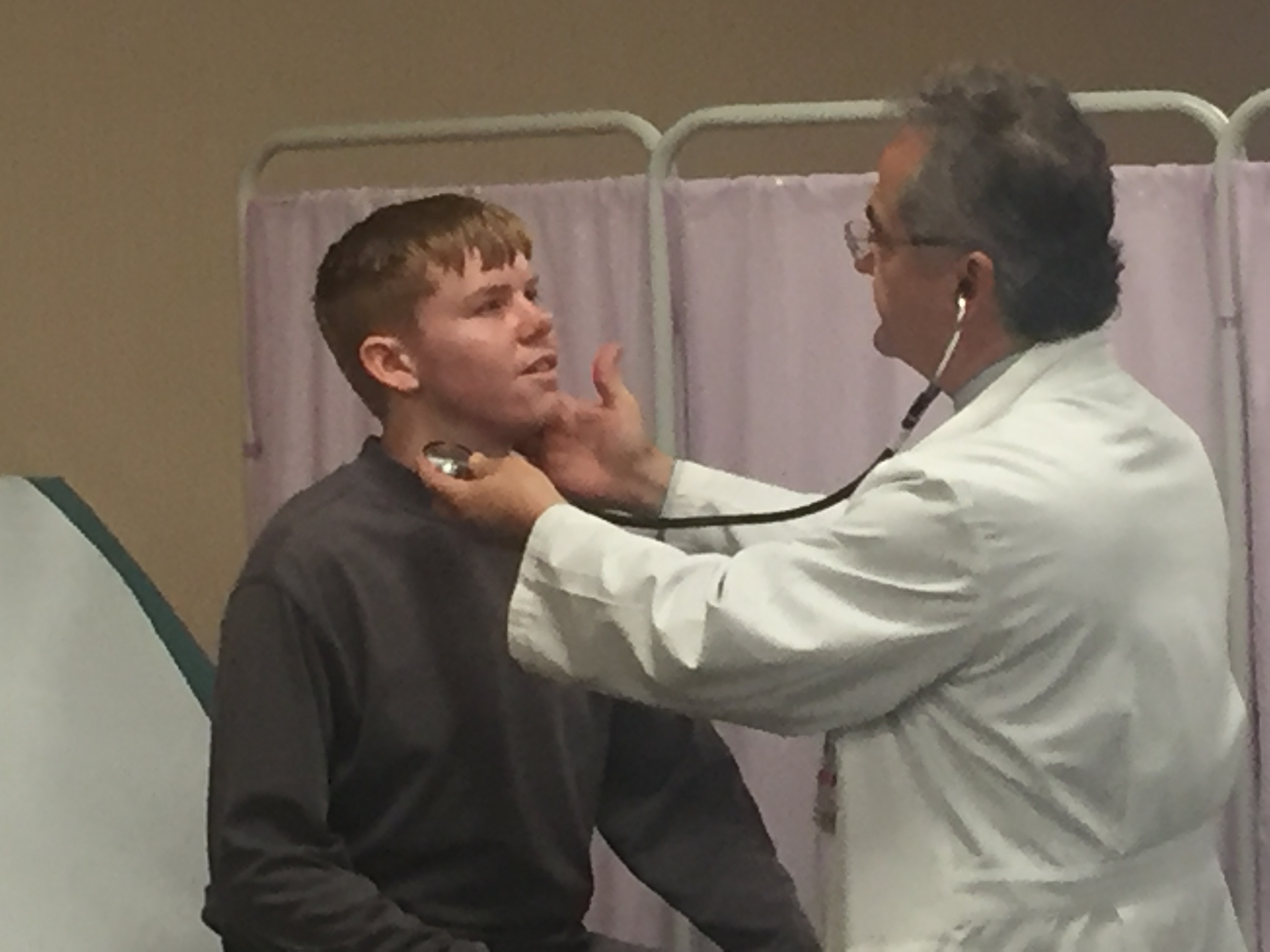 Doctor examining a young adult