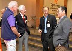 Four men talking at the State of the Hospital Event