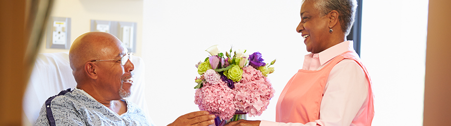 Candy striper bringing flowers to patient